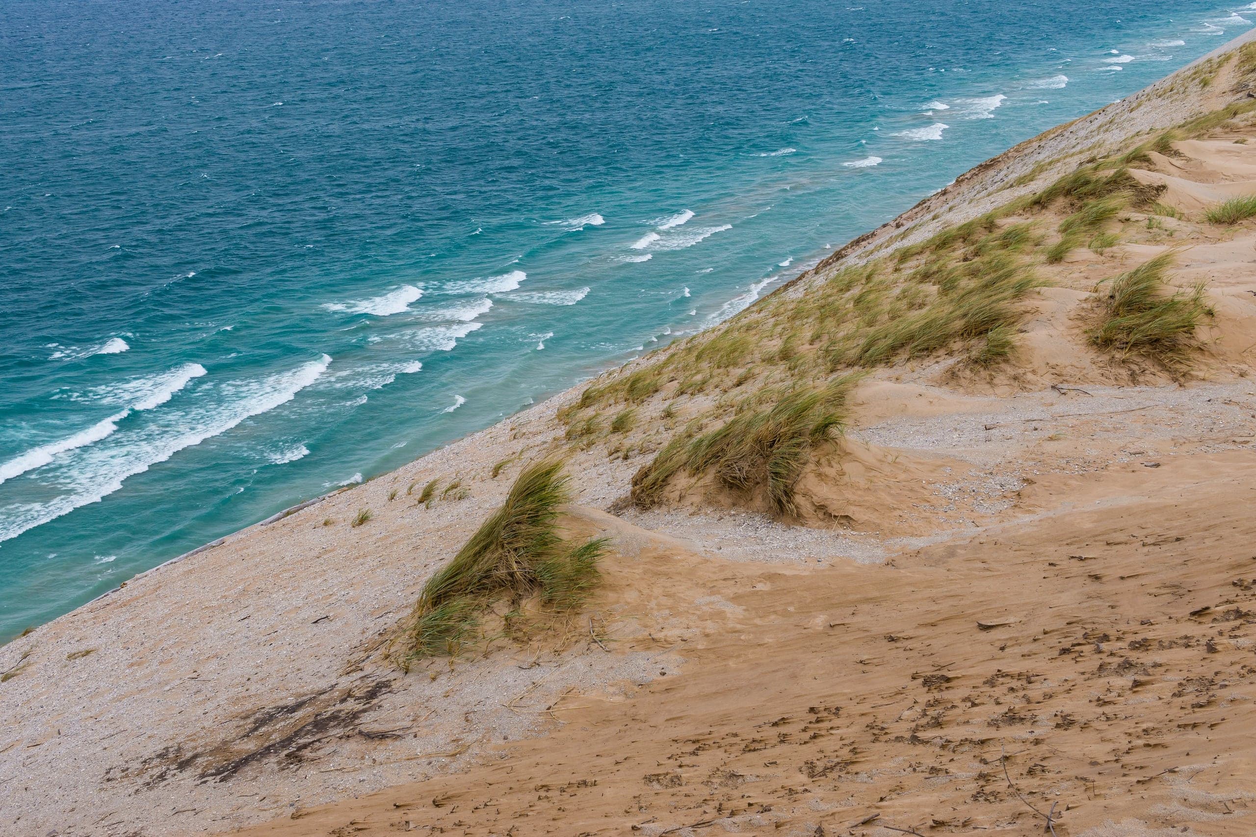 Grassy sand dunes sloping down to Lake Michigan