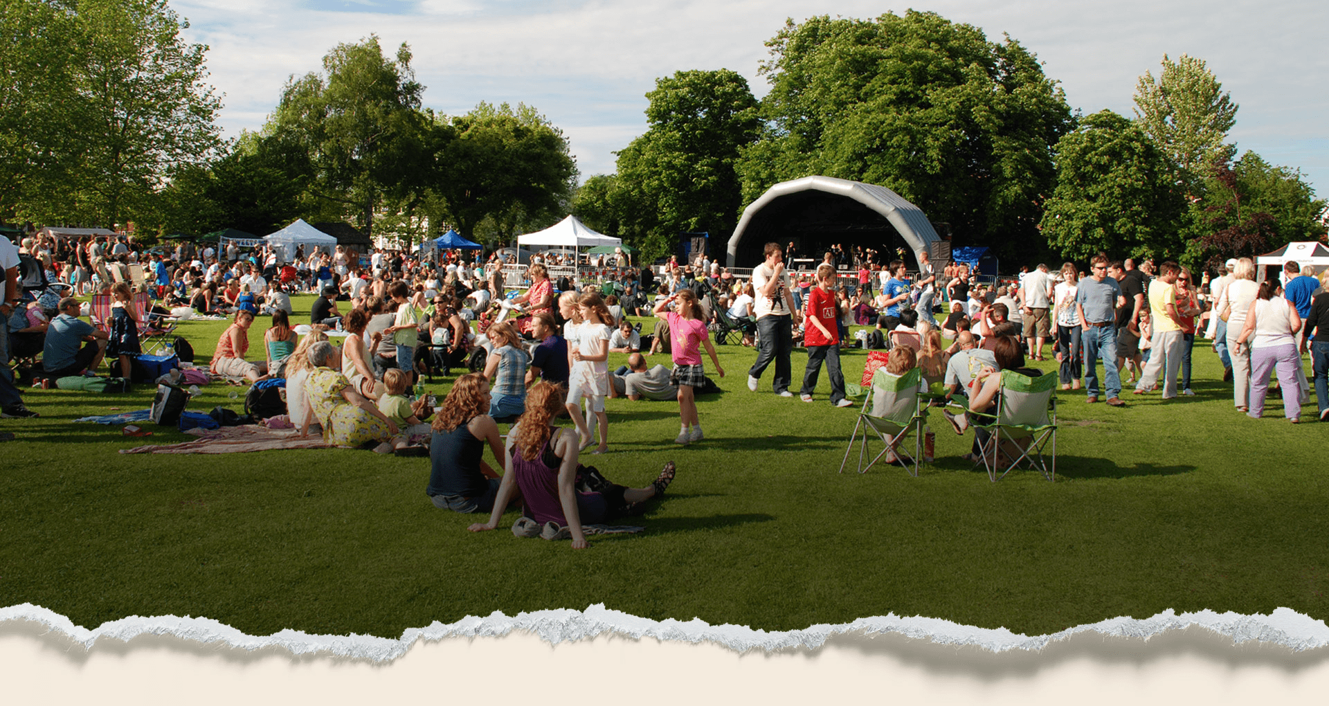 Crowd enjoying an outdoor summer festival in the park