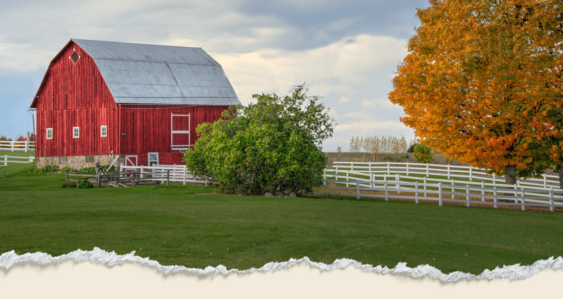 Red barn, white fences, and an autumn maple on a Northern Michigan farm